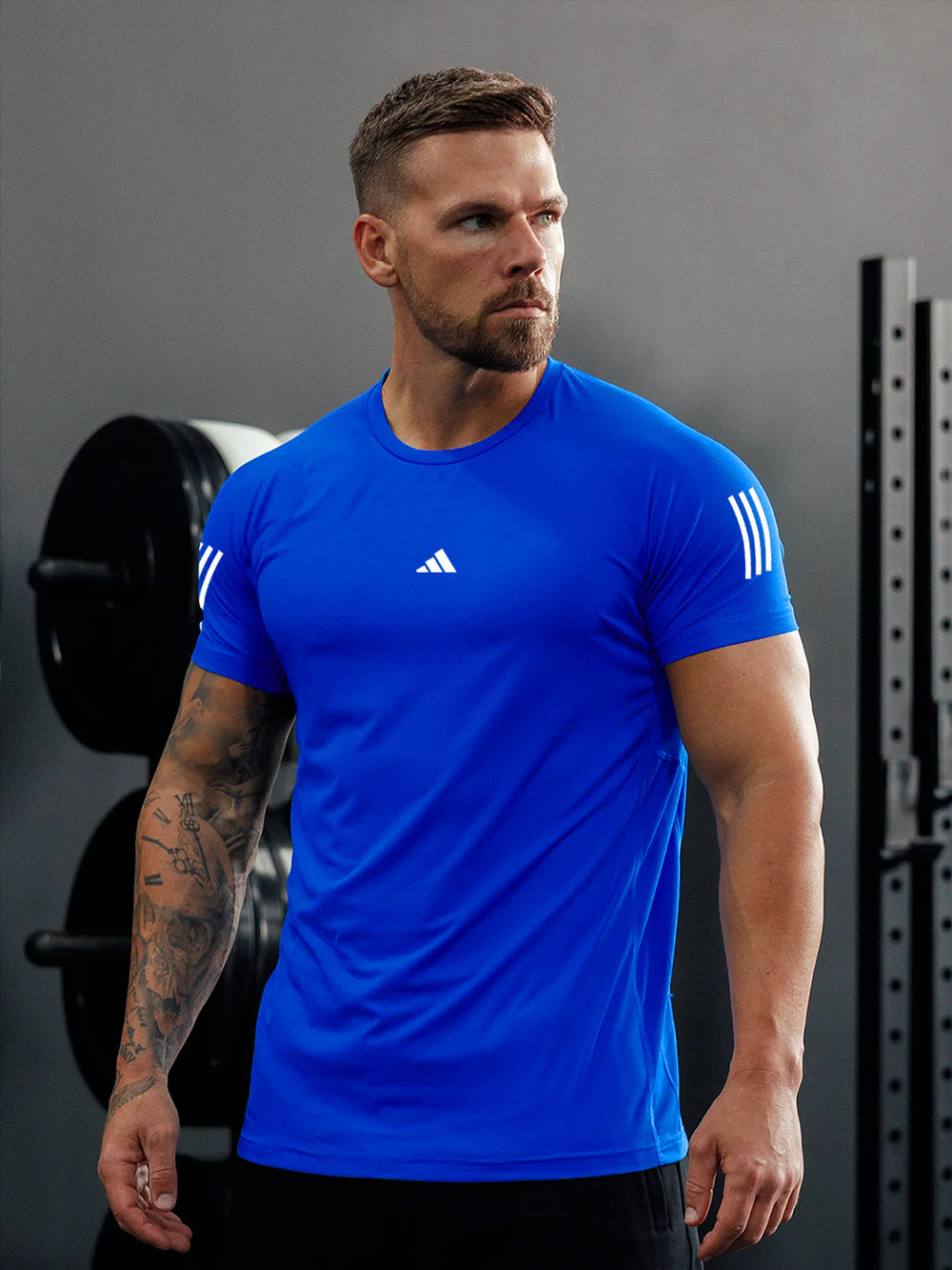 URBAN WOLFS men's blue dry-fit mesh t-shirt on a muscular model in gym showing fitted breathable short sleeve athletic tee