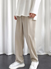 URBAN WOLFS men's beige baggy joggers loose bottom with pleated front and wide relaxed fit shown with white sneakers