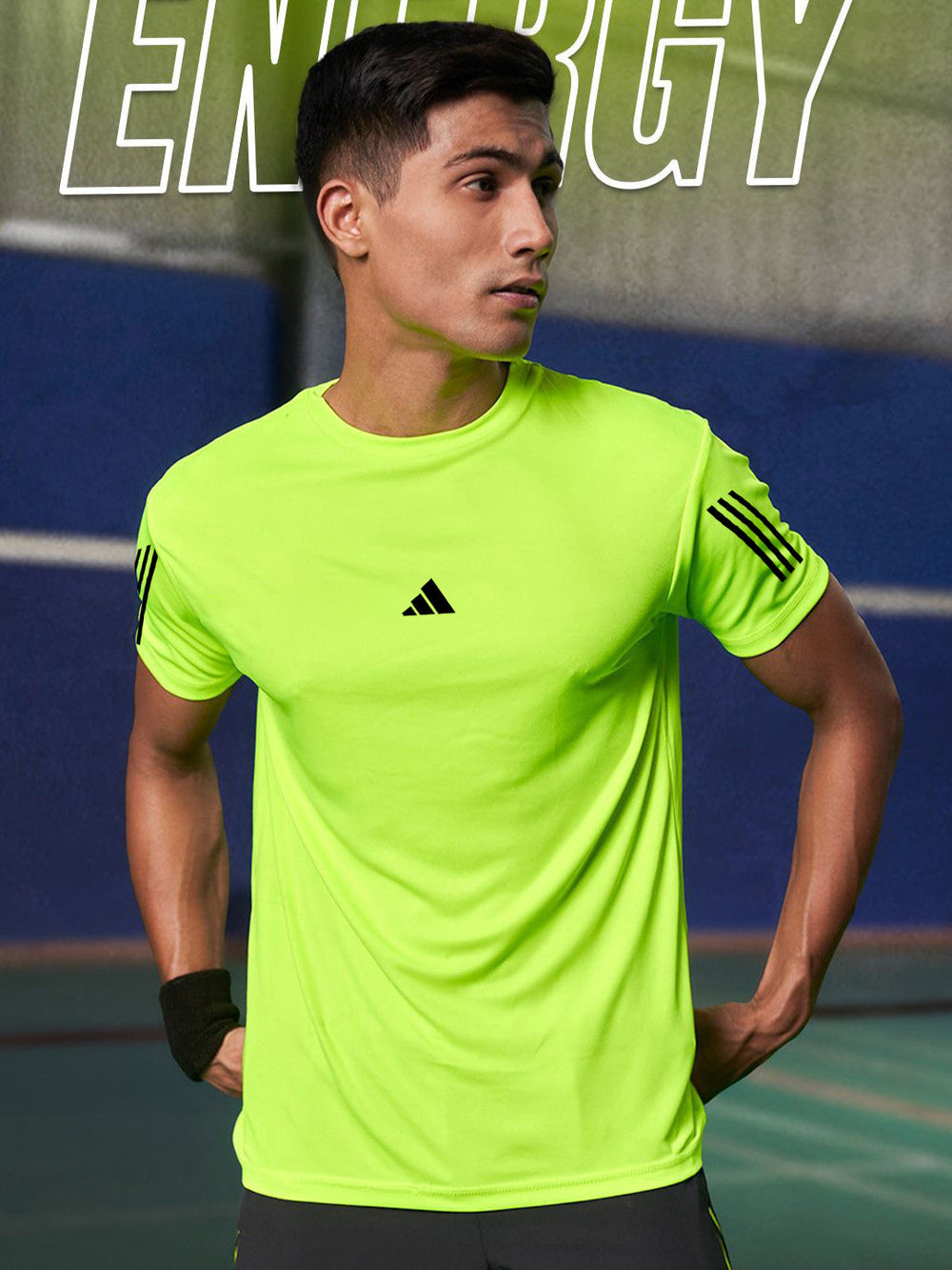 Male model wearing URBAN WOLFS men's lime green dri-fit t-shirt with black logo and sleeve stripes on indoor court