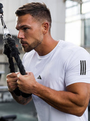 URBAN WOLFS men's white mesh dry-fit tee on fit man using cable machine showing breathable short sleeve gym top