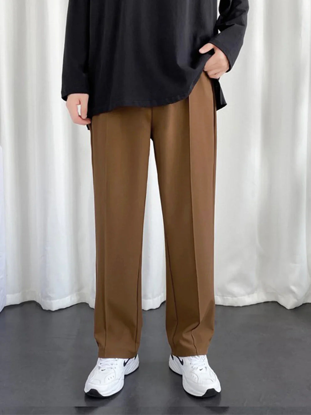 URBAN WOLFS men's brown baggy joggers with straight wide leg and front crease paired with white sneakers