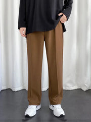 URBAN WOLFS men's brown baggy joggers with straight wide leg and front crease paired with white sneakers