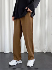 URBAN WOLFS men's brown baggy joggers styled with oversized black top and white sneakers for casual streetwear look