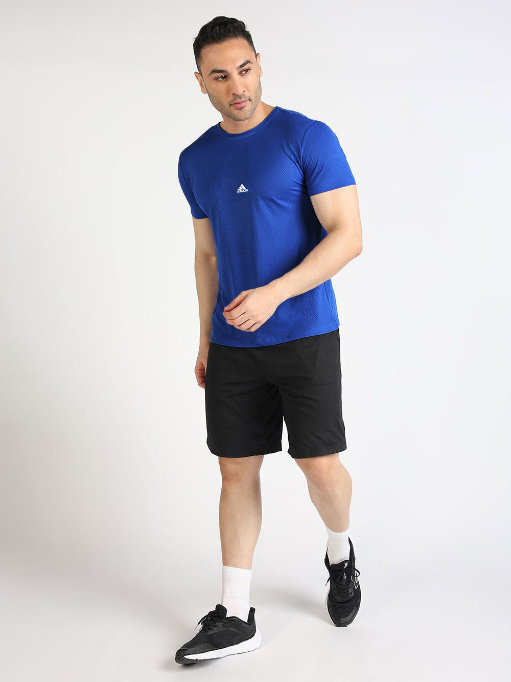 URBAN WOLFS model wearing men's blue dry-fit mesh t-shirt with athletic fit paired with black shorts
