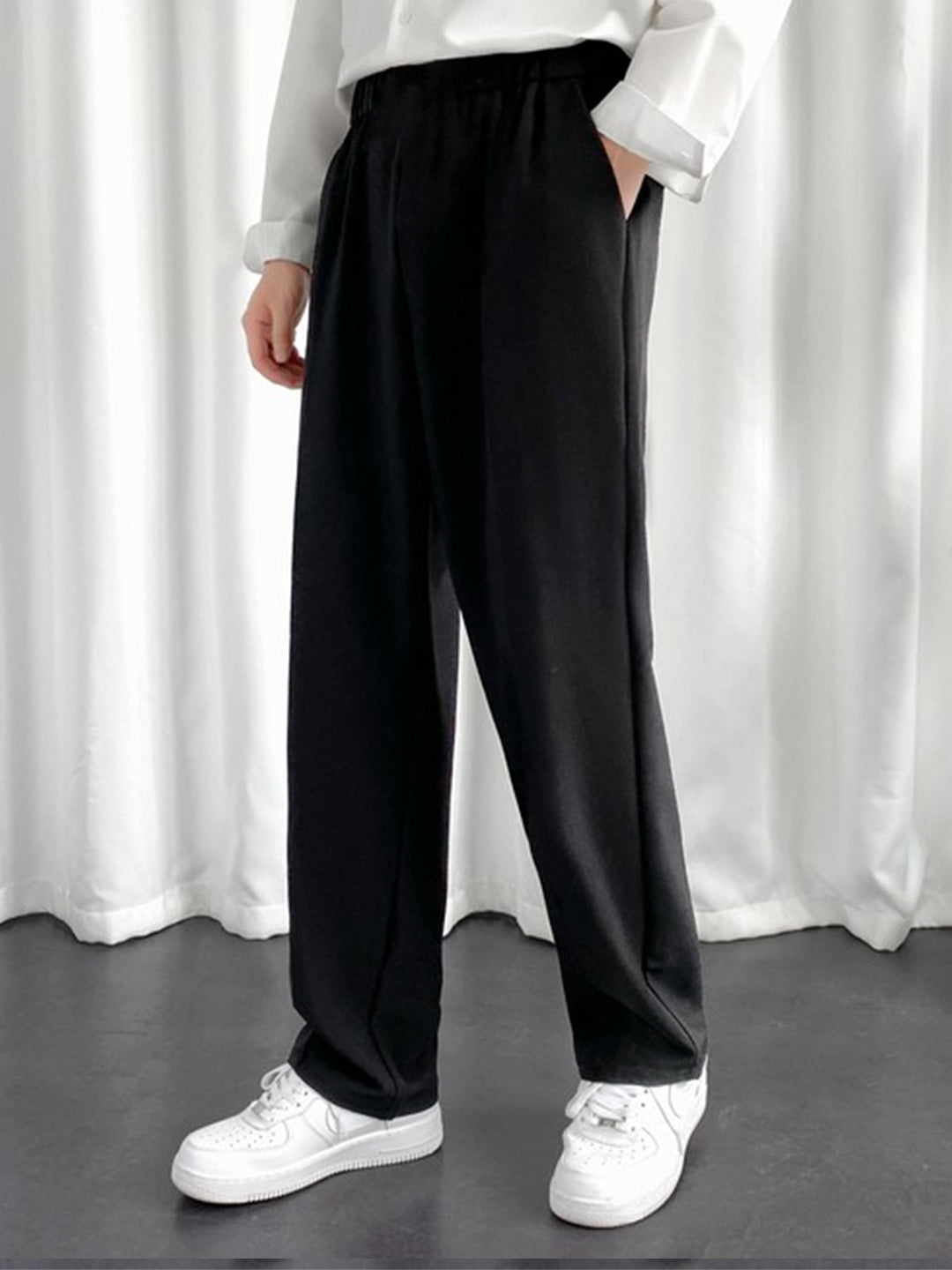 URBAN WOLFS men's black baggy joggers with elastic waistband and side pockets worn with white sneakers