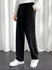 URBAN WOLFS men's black baggy joggers with elastic waistband and side pockets worn with white sneakers